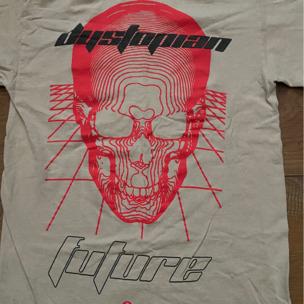 Beige shirt with a red skull with black writing